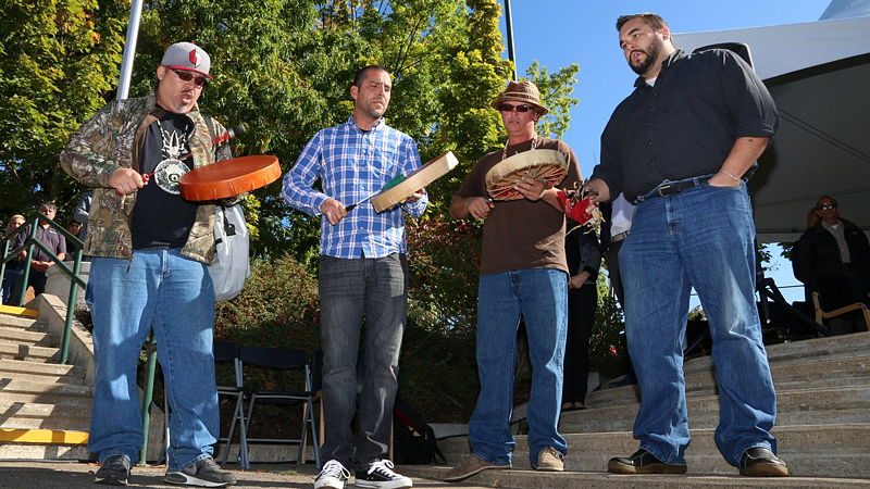 Four men at flag raising ceremony